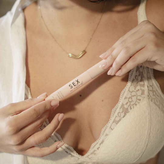A woman holding a tube Sex Au Naturel Clitoral Arousal Gel by Bijoux indiscrets